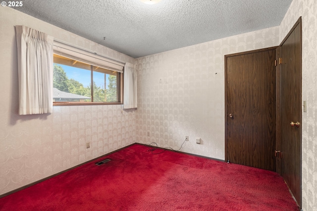 16739 NE Glisan St, Gresham, OR 97230 - unfurnished bedroom featuring carpet floors, wallpapered walls, and a textured ceiling