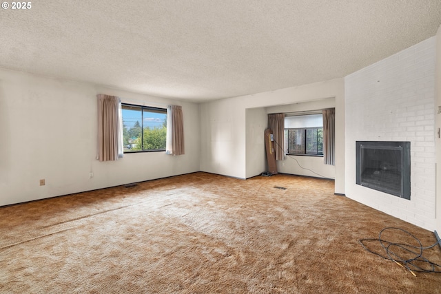 16739 NE Glisan St, Gresham, OR 97230 - unfurnished living room with healthy amount of natural light, a textured ceiling, carpet, and a fireplace