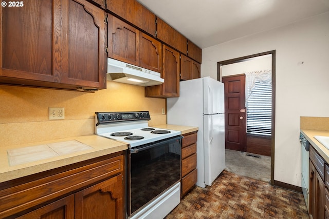16739 NE Glisan St, Gresham, OR 97230 - kitchen with white appliances, under cabinet range hood, light countertops, and brown cabinetry