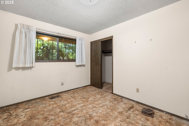 16739 NE Glisan St, Gresham, OR 97230 - unfurnished bedroom featuring a textured ceiling, a closet, and carpet floors
