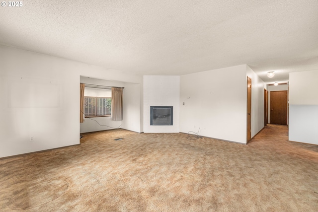 16739 NE Glisan St, Gresham, OR 97230 - unfurnished living room featuring carpet, a glass covered fireplace, and a textured ceiling