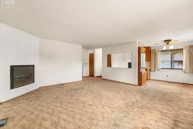 16739 NE Glisan St, Gresham, OR 97230 - unfurnished living room with carpet floors, a textured ceiling, a fireplace, and a ceiling fan