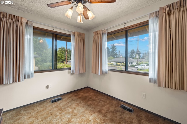 16739 NE Glisan St, Gresham, OR 97230 - unfurnished room with ceiling fan, dark carpet, plenty of natural light, and a textured ceiling