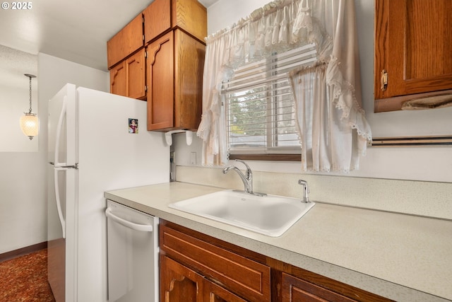 16739 NE Glisan St, Gresham, OR 97230 - kitchen featuring white appliances, brown cabinetry, light countertops, and decorative light fixtures