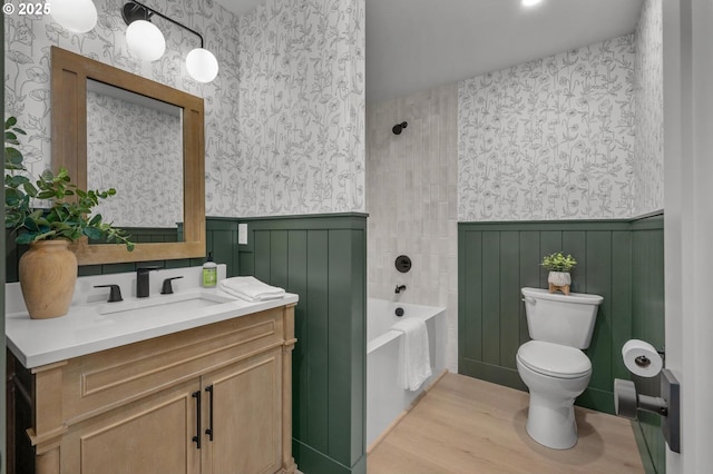 19666 Kapteyns St, West Linn, OR 97068 - bathroom with vanity, wainscoting, toilet, wood finished floors, and washtub / shower combination