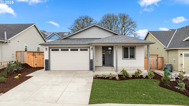 view of front of home featuring a front lawn, fence, concrete driveway, roof with shingles, and an attached garage