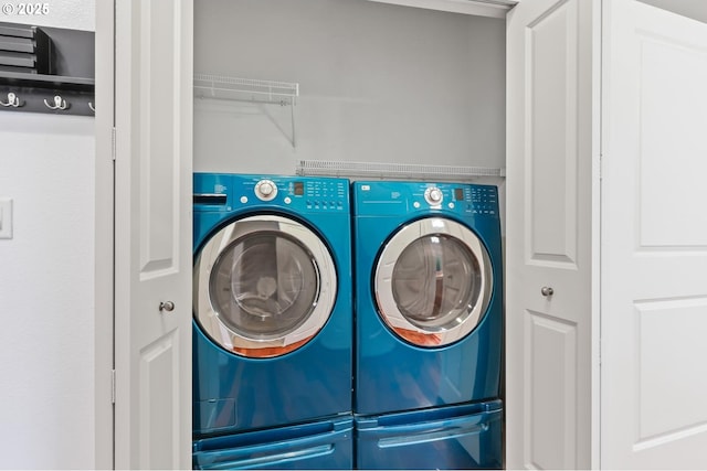 clothes washing area with washer and dryer and laundry area