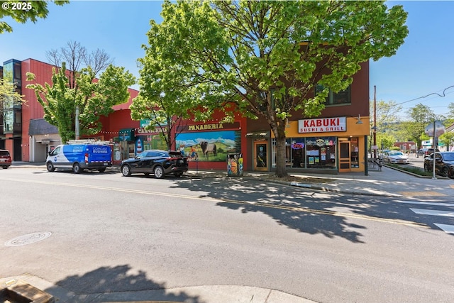 view of street with street lighting, sidewalks, and curbs