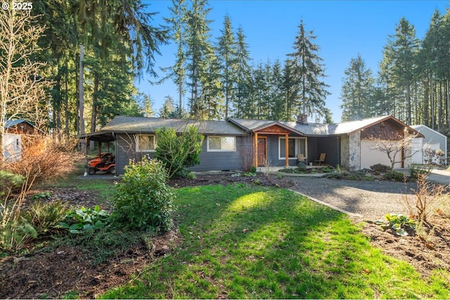 ranch-style home with a garage and a front lawn