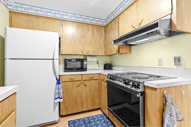 1120 N Lupine Ct, Canby, OR 97013 - kitchen with freestanding refrigerator, range with electric stovetop, black microwave, under cabinet range hood, and light countertops