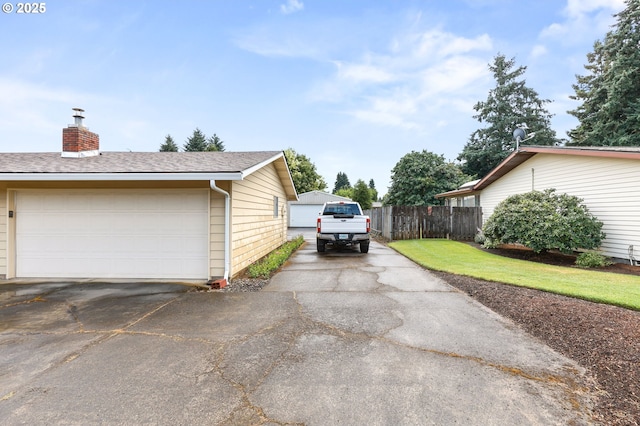 1120 N Lupine Ct, Canby, OR 97013 - view of side of home featuring a chimney, roof with shingles, and a detached garage