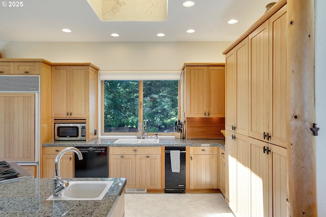 kitchen featuring dishwasher, a sink, built in fridge, stainless steel microwave, and light brown cabinets
