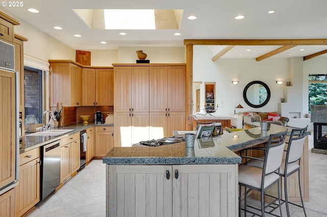 kitchen featuring a skylight, stainless steel dishwasher, recessed lighting, and open floor plan
