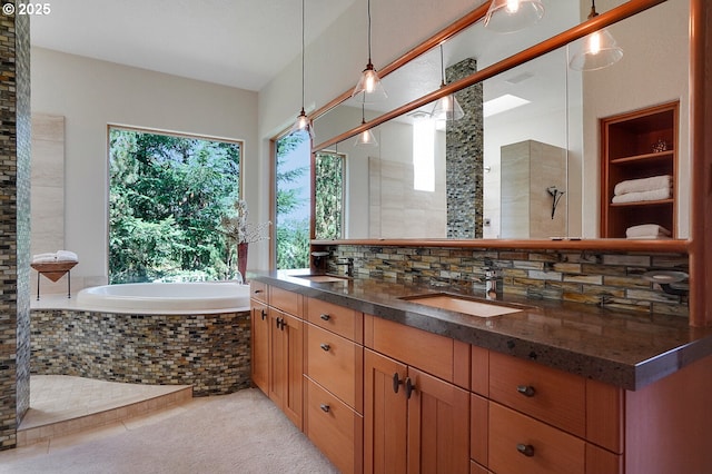 bathroom featuring double vanity, a sink, a bath, and a tile shower