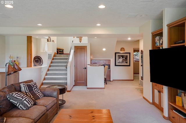 living room with baseboards, light carpet, recessed lighting, and stairs