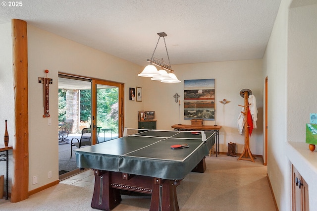 game room with a textured ceiling, light colored carpet, and baseboards