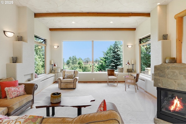 carpeted living area featuring baseboards, recessed lighting, a fireplace, and beamed ceiling
