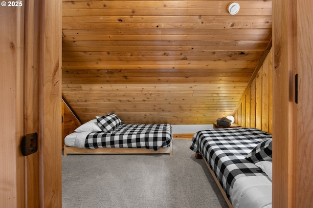 bedroom featuring carpet floors and wooden walls