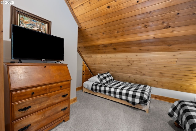 carpeted bedroom with lofted ceiling, baseboards, wood ceiling, and wooden walls