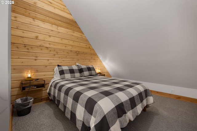 carpeted bedroom featuring wood walls