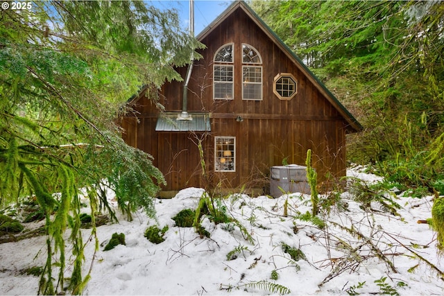 view of property exterior featuring a detached garage, a barn, and an outdoor structure