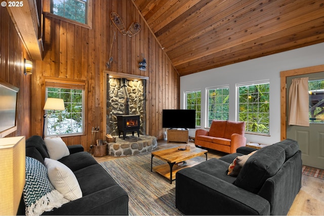 living area featuring plenty of natural light, wood walls, wooden ceiling, and light wood-style flooring