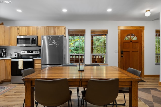 kitchen featuring stainless steel appliances, recessed lighting, and light wood-style floors