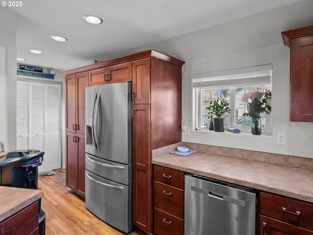 kitchen featuring recessed lighting, light wood-style floors, light countertops, and appliances with stainless steel finishes