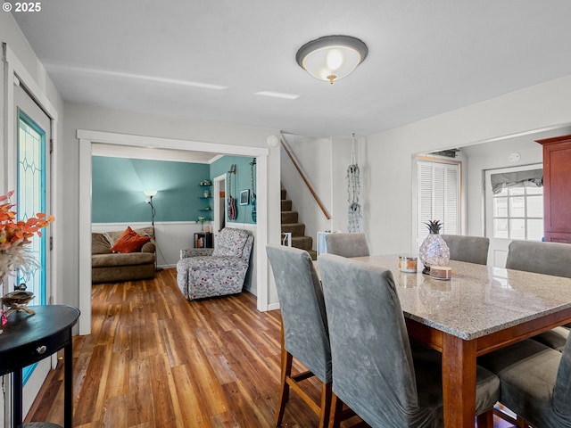 dining area featuring stairway and hardwood / wood-style flooring