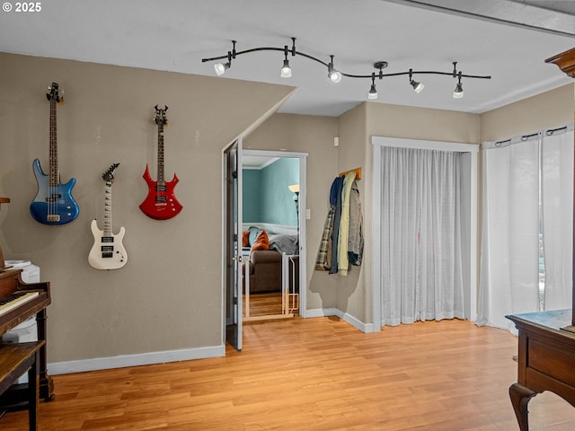 interior space with baseboards and light wood-type flooring