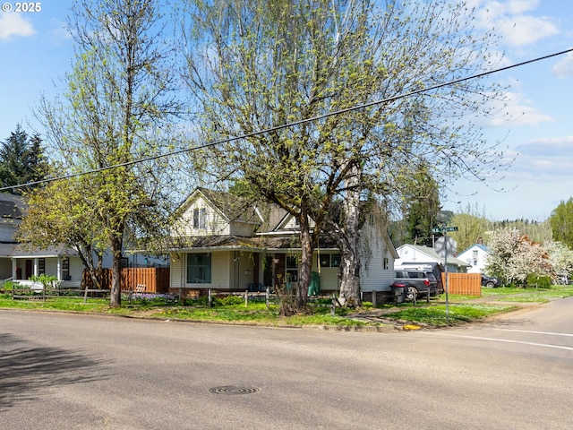 view of front facade with fence and a porch