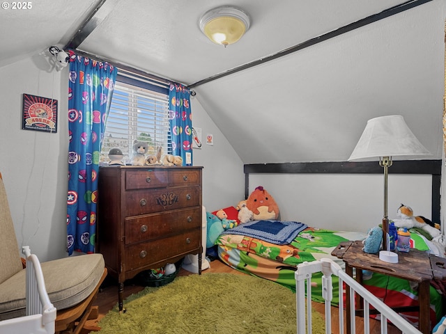 bedroom featuring lofted ceiling and wood finished floors