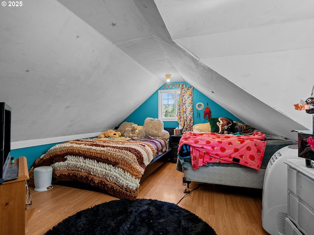 bedroom featuring vaulted ceiling and wood finished floors