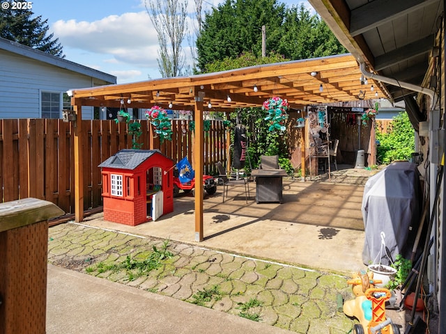 view of patio with grilling area and fence