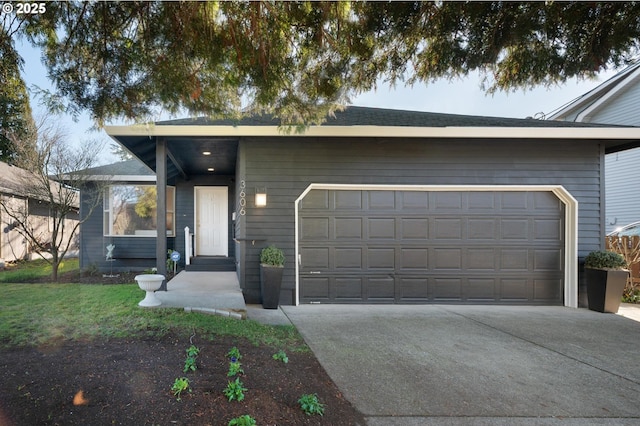 view of front facade with a garage and concrete driveway