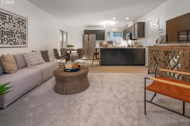 living area featuring recessed lighting and light colored carpet