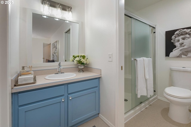 full bath with toilet, a stall shower, baseboards, and vanity