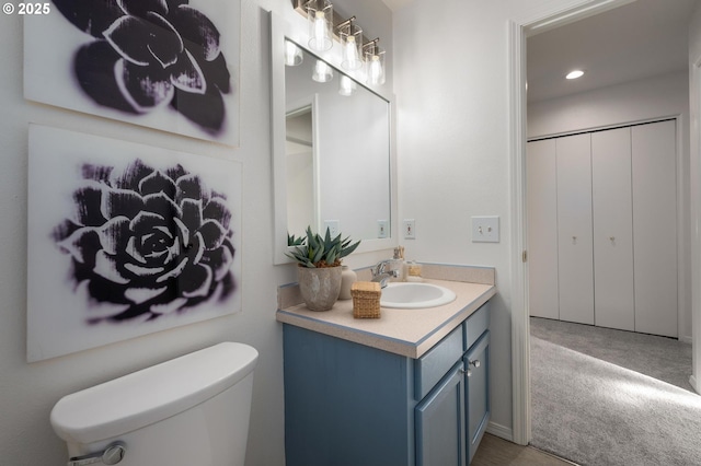 bathroom with toilet and vanity