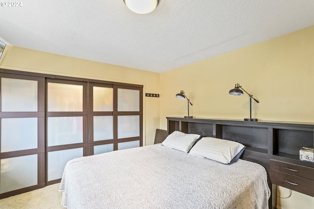 carpeted bedroom with a textured ceiling