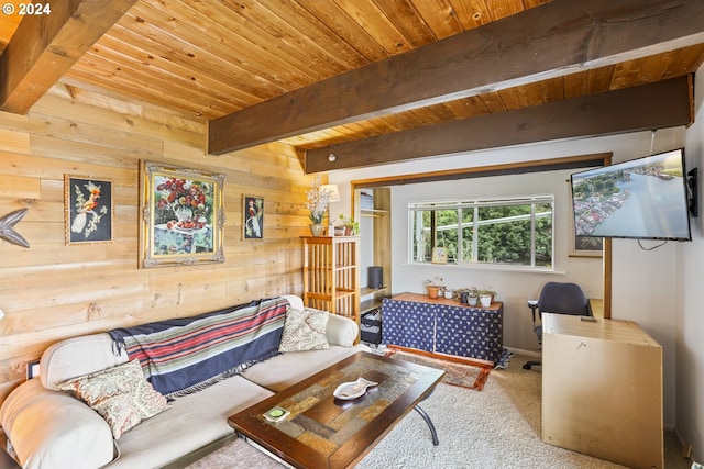 carpeted living room with beamed ceiling, wooden walls, and wood ceiling