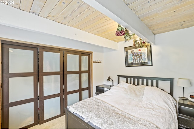 bedroom with carpet floors and wooden ceiling