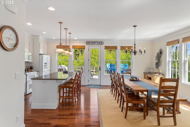 dining area with dark wood-style floors, a chandelier, recessed lighting, and crown molding