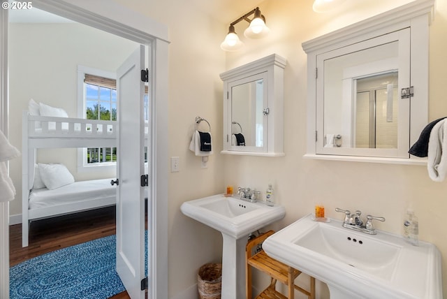 bathroom with a sink and wood finished floors