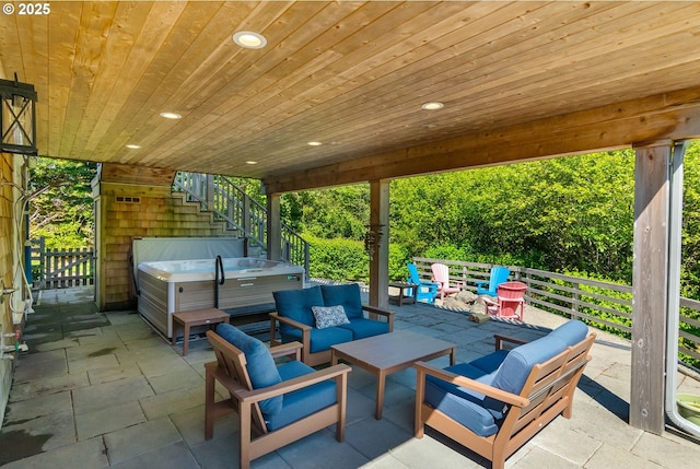 view of patio featuring a hot tub, an outdoor hangout area, and stairway
