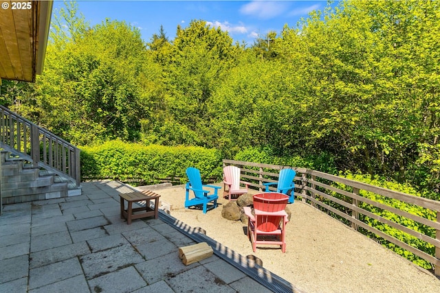 view of patio / terrace with a fire pit and stairway
