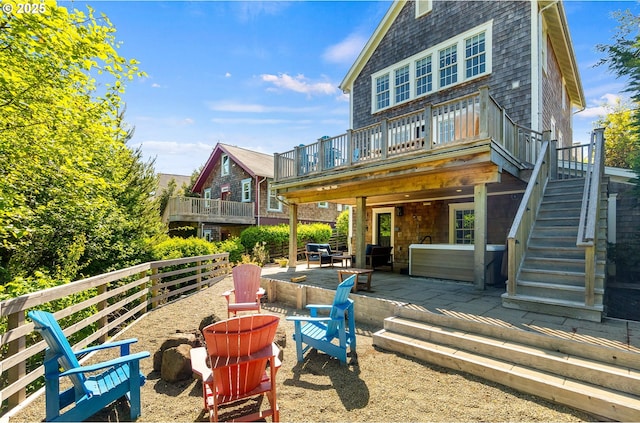 back of property featuring a patio area, a fire pit, a wooden deck, and stairway