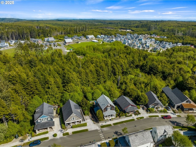 aerial perspective of suburban area featuring a forest