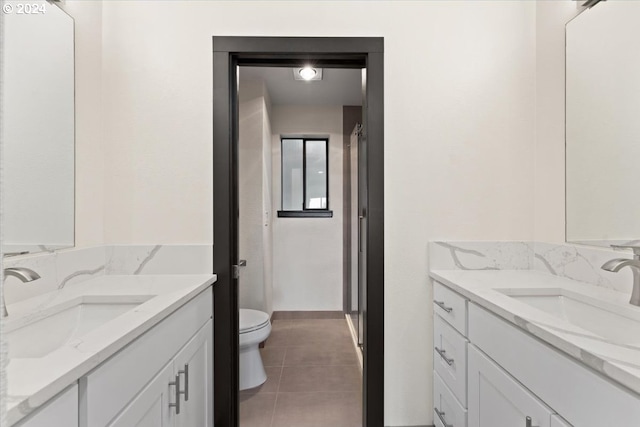 bathroom featuring tile patterned flooring, vanity, and toilet