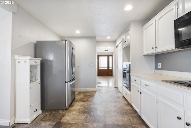 461 NE 16th Ave, Hillsboro, OR 97124 - kitchen featuring black appliances, baseboards, white cabinetry, light countertops, and stone finish floors