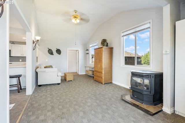 461 NE 16th Ave, Hillsboro, OR 97124 - living area with a wood stove, ceiling fan, lofted ceiling, light colored carpet, and baseboards